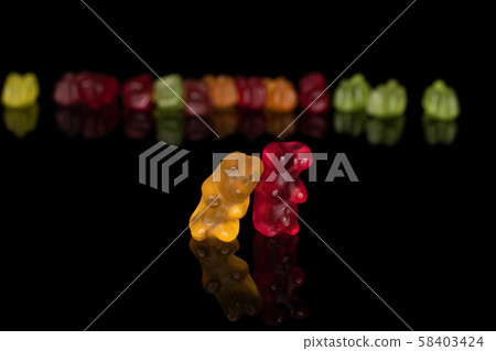 Colorful gummy bear isolated on black glass 58403424