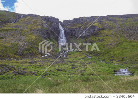 Glumsstadafoss waterfall in fljotsvatn cove in west fjords nature reserve Hornstrandir in Iceland in Glumsstadafoss waterfall in fljotsvatn cove in west fjords nature reserve Hornstrandir in Iceland in 58403604