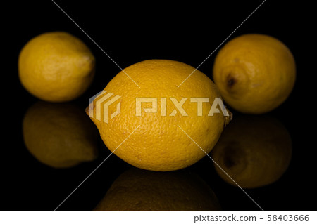 Fresh yellow lemon isolated on black glass Fresh yellow lemon isolated on black glass 58403666