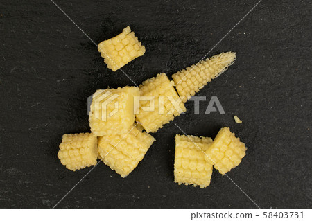 Pickled baby corn on grey stone Pickled baby corn on grey stone 58403731