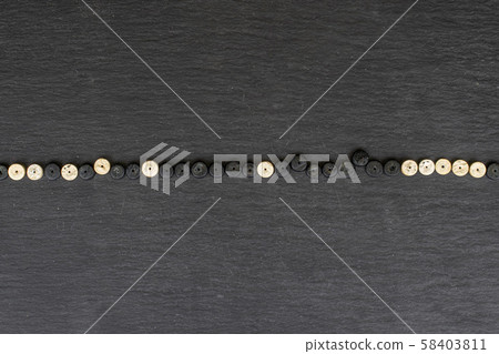 Colorful wooden bead on grey stone Colorful wooden bead on grey stone 58403811