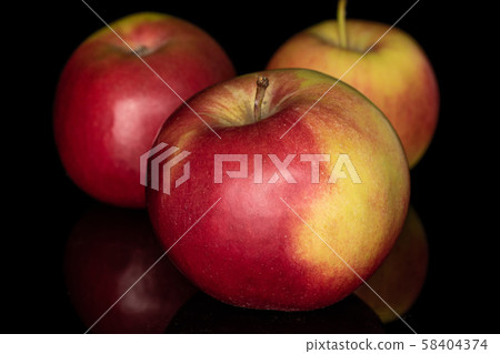 Red jonagold apple isolated on black glass 58404374