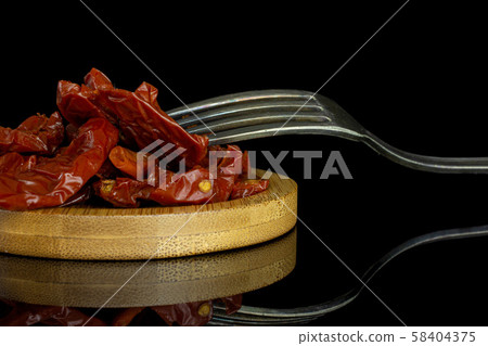 Dry red cherry tomato isolated on black glass Dry red cherry tomato isolated on black glass 58404375