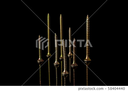 Glossy metallic bolt isolated on black glass Glossy metallic bolt isolated on black glass 58404440