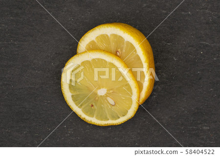 Fresh yellow lemon on grey stone Fresh yellow lemon on grey stone 58404522