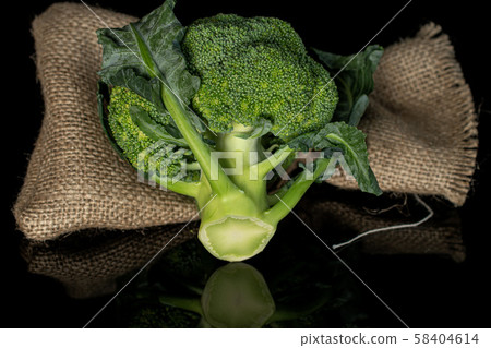 Fresh green broccoli isolated on black glass 58404614