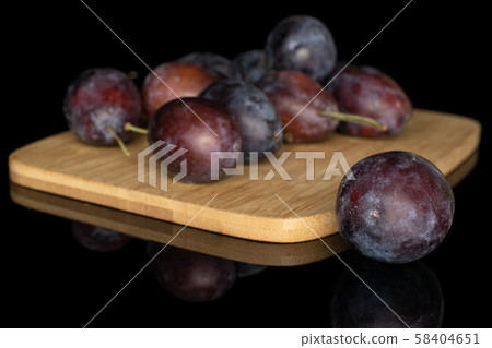 Sweet purple plum isolated on black glass Sweet purple plum isolated on black glass 58404651