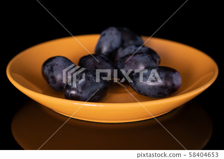 Fresh black wine grape isolated on black glass Fresh black wine grape isolated on black glass 58404653
