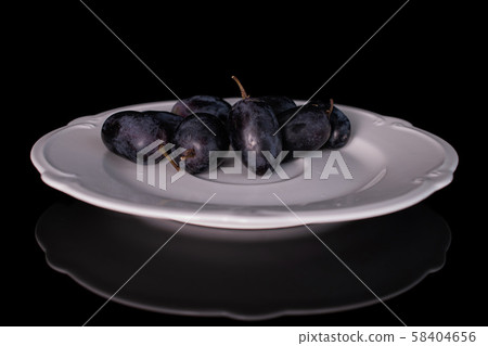 Fresh black wine grape isolated on black glass Fresh black wine grape isolated on black glass 58404656