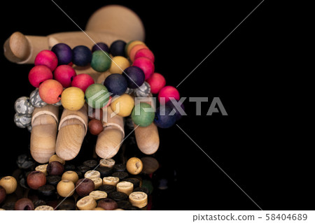 Colorful wooden bead isolated on black glass Colorful wooden bead isolated on black glass 58404689