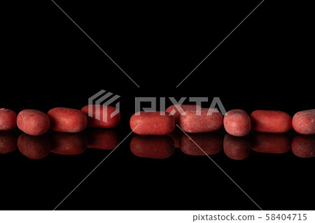 Sweet pastel candy isolated on black glass 58404715