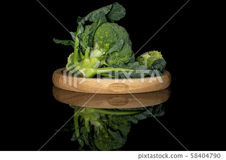 Fresh green broccoli isolated on black glass Fresh green broccoli isolated on black glass 58404790