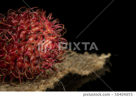 Fresh red rambutan isolated on black glass Fresh red rambutan isolated on black glass 58404855