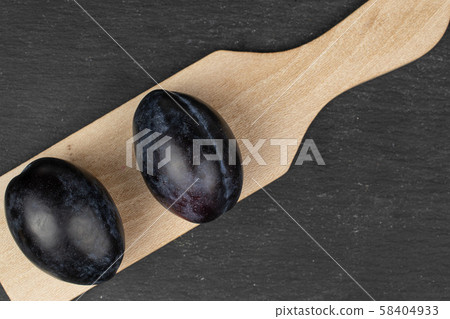 Fresh purple plum on grey stone 58404933