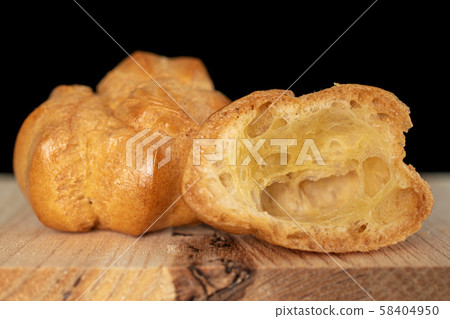 Golden baked profiterole isolated on black glass Golden baked profiterole isolated on black glass 58404950