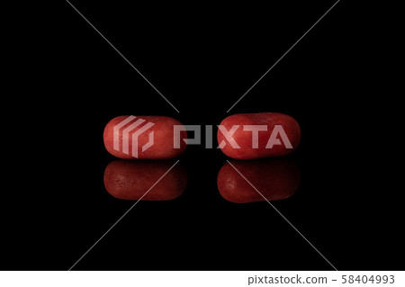 Sweet pastel candy isolated on black glass Sweet pastel candy isolated on black glass 58404993