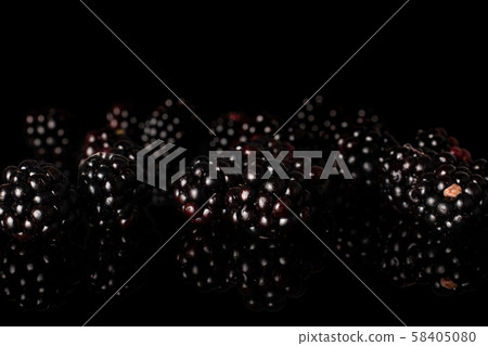 Fresh blackberry isolated on black glass 58405080