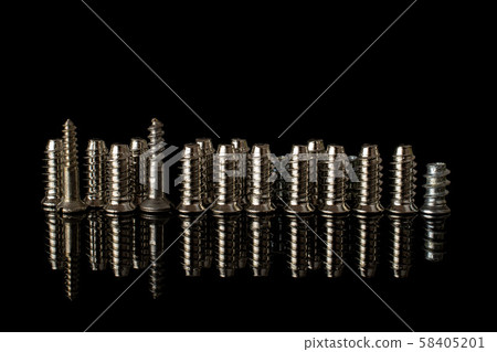 Glossy metallic bolt isolated on black glass Glossy metallic bolt isolated on black glass 58405201