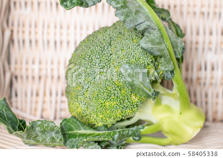 Fresh green broccoli with braided rattan Fresh green broccoli with braided rattan 58405338
