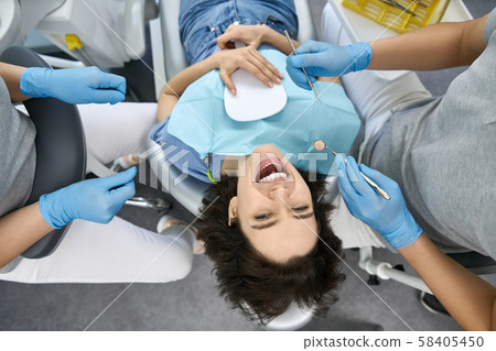 Pretty woman's teeth treatment in dental clinic Pretty woman's teeth treatment in dental clinic 58405450