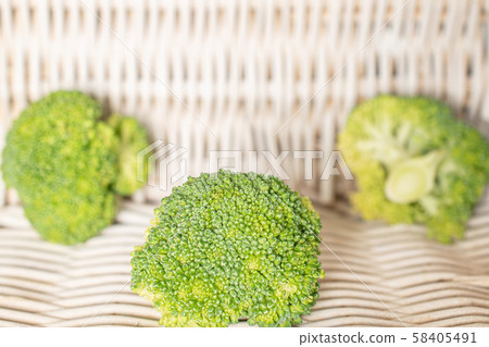 Fresh green broccoli with braided rattan Fresh green broccoli with braided rattan 58405491