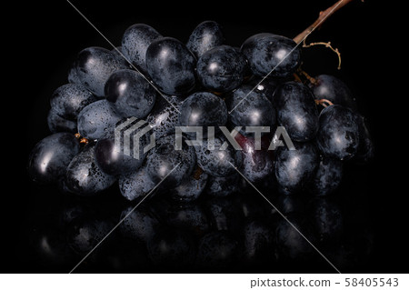 Fresh black wine grape isolated on black glass Fresh black wine grape isolated on black glass 58405543