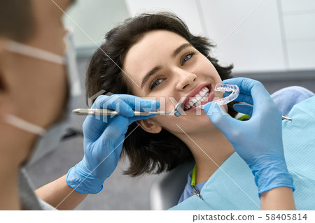 Pretty woman's teeth treatment in dental clinic Pretty woman's teeth treatment in dental clinic 58405814