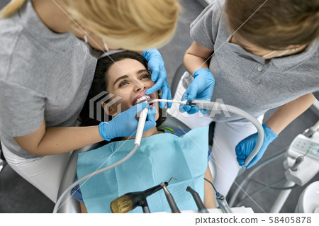 Pretty woman's teeth treatment in dental clinic Pretty woman's teeth treatment in dental clinic 58405878