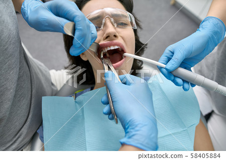 Pretty woman's teeth treatment in dental clinic Pretty woman's teeth treatment in dental clinic 58405884