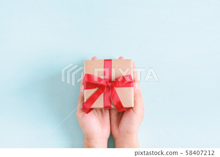 Hand holding gift box for giving 58407212