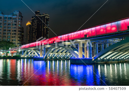 Illuminated night view of Kaohsiung's buildings and Love River 58407509
