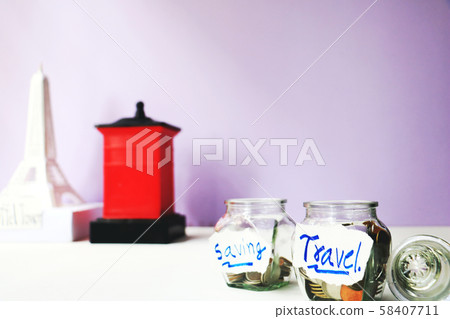 The coins in bottle and model Eiffel Tower on background. save money for future. The concept save money for travel on a white background. The coins in bottle and model Eiffel Tower on background. save money for future. The concept save money for travel on a white background. 58407711