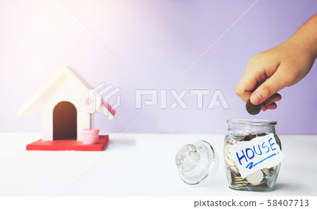 Saving money. A hand putting money in bottle.The coins in the bottle for save money.Photo financial saving and Saving money. Saving money. A hand putting money in bottle.The coins in the bottle for save money.Photo financial saving and Saving money. 58407713