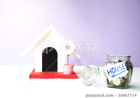 The coins in bottle and model home on background.save money for future.The concept of growth for the save money. The coins in bottle and model home on background.save money for future.The concept of growth for the save money. 58407714