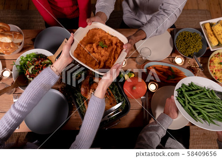 Millennial adult friends celebrating Thanksgiving together at home Millennial adult friends celebrating Thanksgiving together at home 58409656