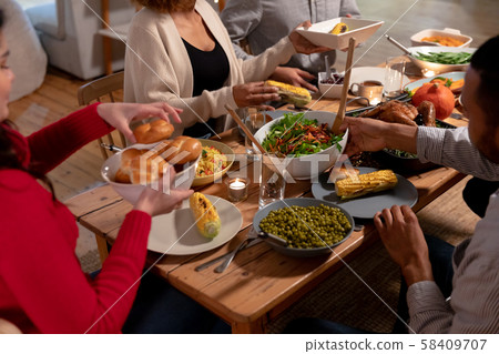 Millennial adult friends celebrating Thanksgiving together at home Millennial adult friends celebrating Thanksgiving together at home 58409707
