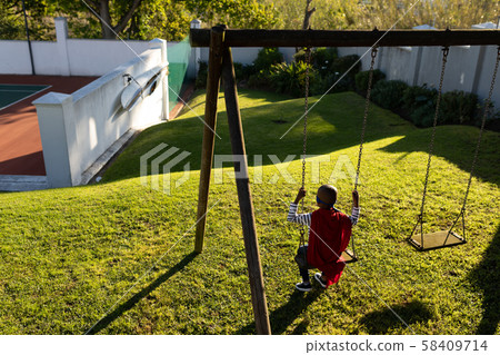 Superhero boy in garden Superhero boy in garden 58409714
