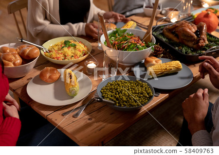 Millennial adult friends celebrating Thanksgiving together at home Millennial adult friends celebrating Thanksgiving together at home 58409763