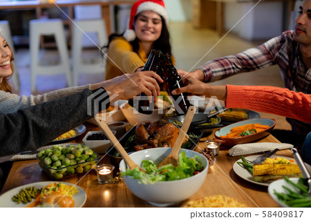 Millennial adult friends celebrating Christmas together at home 58409817