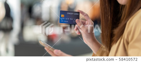 banner of Asian woman using credit card with mobile phone for online shopping in department store over the clothes shop store, technology money wallet and online payment concept, credit card mockup banner of Asian woman using credit card with mobile phone for online shopping in department store over the clothes shop store, technology money wallet and online payment concept, credit card mockup 58410572