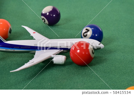 Airplane and billiard balls 58415534