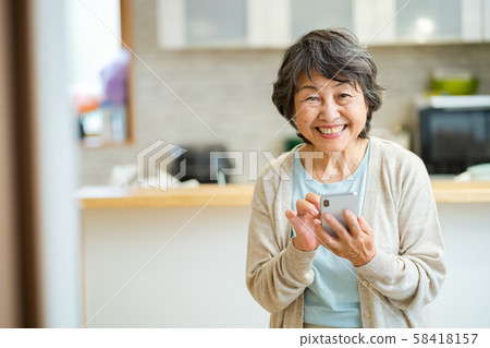 Smiling senior woman Senior woman with smartphone Silver generation elderly woman portrait 58418157