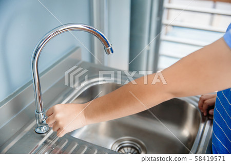 hand at water tap sink in kitchen to cleaning hand hand at water tap sink in kitchen to cleaning hand 58419571