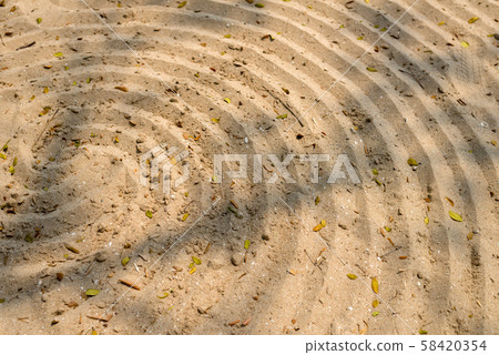 Spiral pattern design in sand on the beach Spiral pattern design in sand on the beach 58420354