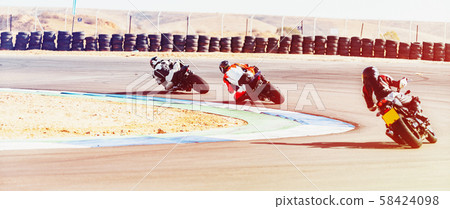 motorcycle racer rides on a sports track 58424098