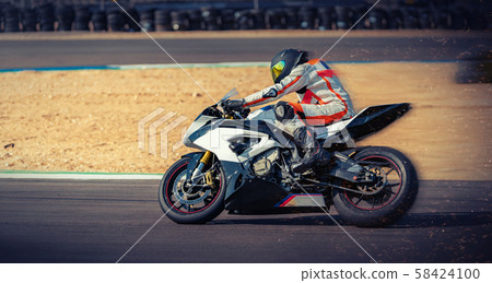motorcycle racer rides on a sports track 58424100