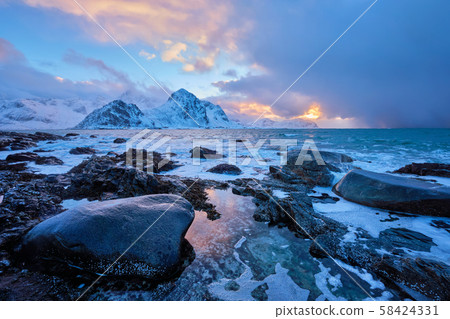 Coast of Norwegian sea on rocky coast in fjord on sunset 58424331