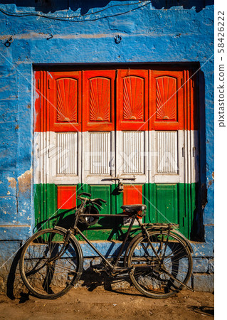 Bicycle and door painted in India national flag colors. Jodhpur, India 58426222