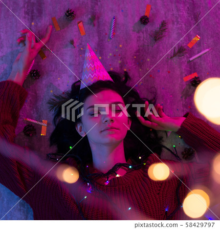 Portrait of young woman with christmas lights on her body. Portrait of young woman with christmas lights on her body. 58429797