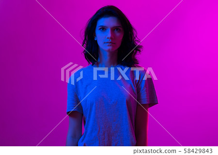 Young woman in pink blue neon lights. Creative colorful portrait Young woman in pink blue neon lights. Creative colorful portrait 58429843